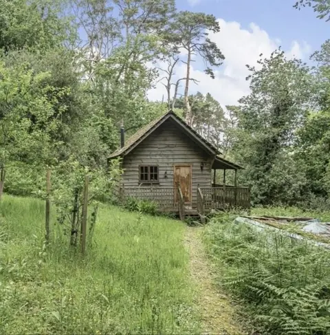 The wooden cabin in the middle of the wood